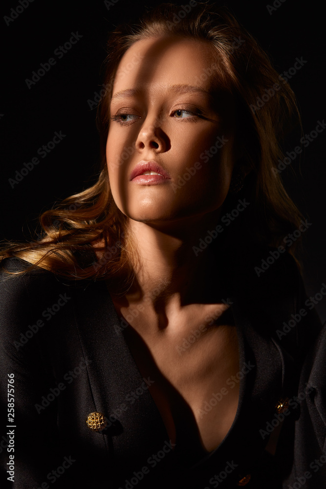 Fototapeta premium Surrealist portrait. Dramatic portrait of a girl in the dark. Fashion sexy girl. ..