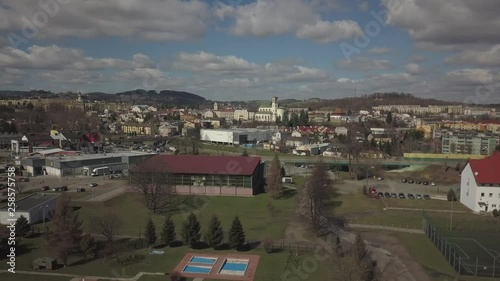 Gorlice, Poland - 3 9 2019: Panorama of the historic center of the European medieval city on the picturesque green hills. Trips to architectural monuments, temples, quarters and sports complex MOSiR photo