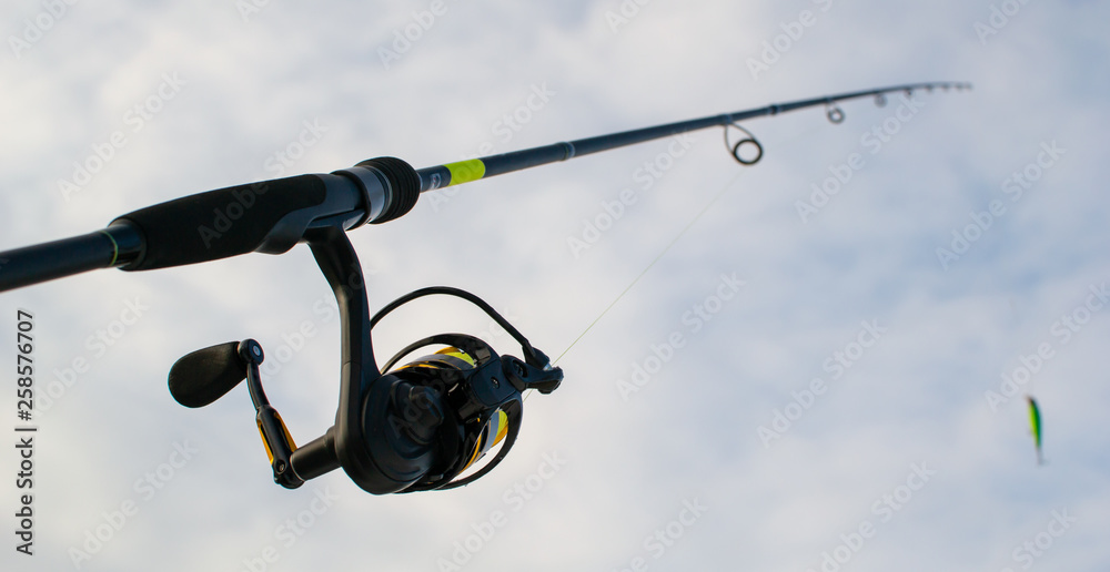 Fishing gear. Blue sky. Fishing with spinning. Fishing gear. Blue sky. Fishing with spinning.