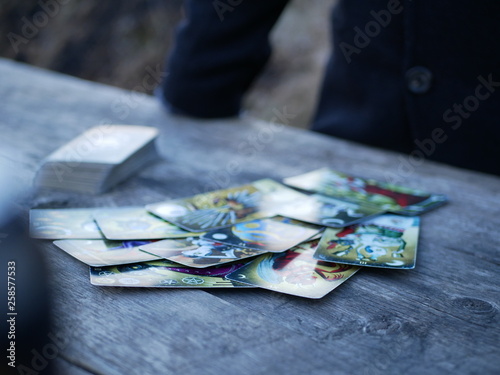 Polonne / Ukraine - 5 March 2019: A man in a coat spreads a pack of tarot cards