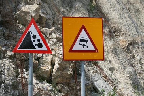 Two warning road signs in the mountains