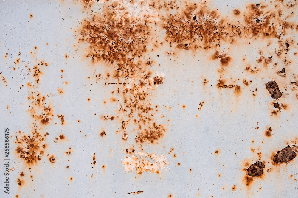 Background texture of old rusty damaged metal. Remains of multi-colored paint on an iron sheet. Background texture of old rusty damaged metal. Remains of multi-colored paint on an iron sheet.