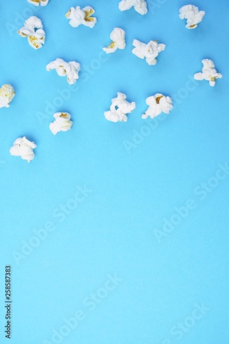 Single popcorn on a monochrome background - concept with fresh made popcorn on a monochrome background