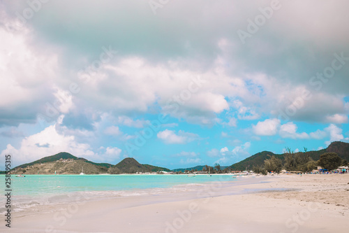 Idyllic tropical beach with white sand, turquoise ocean water and blue sky