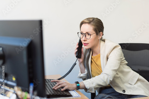 Worker wman in office looking computer photo