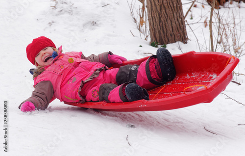 A little girl (3 yr old) sledging in Quebec photo