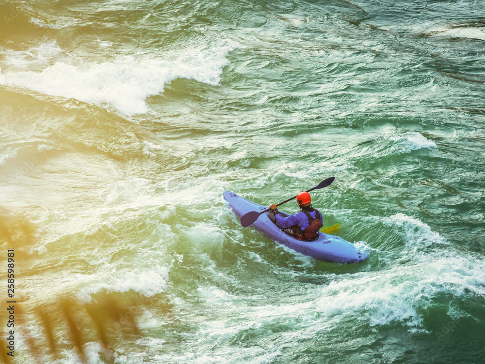 top view of Whitewater kayaking, extreme kayaking. A guy in a kayak sails on a mountain river Ganges in Rishikesh,  India