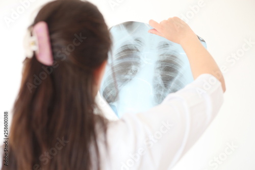 Female doctor looking at an x-ray in a hospital photo
