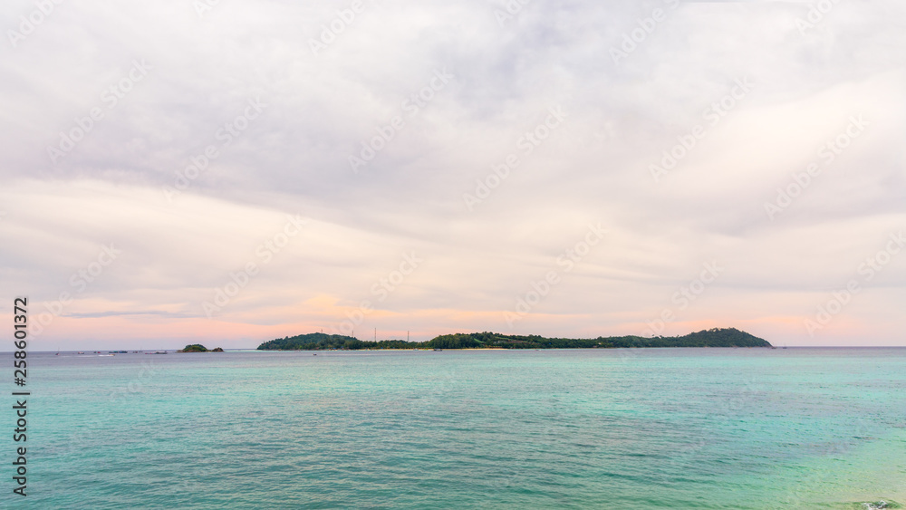 Beautiful nature landscape of the Andaman Sea surrounds Ko Lipe island under the sky during the sunset in summer at Tarutao National Park, famous attractions of Satun, Thailand, 16:9, widescreen