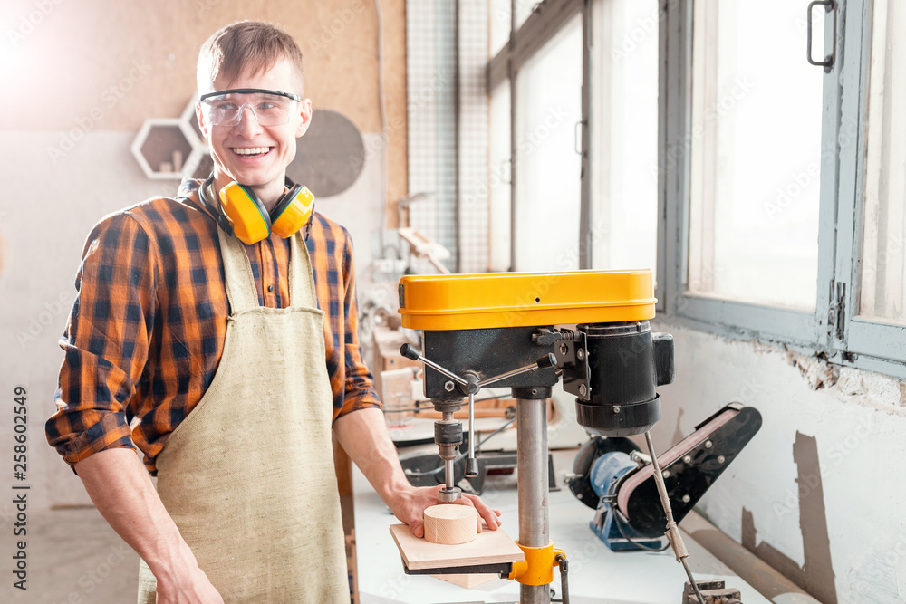 Professional craftsman working on drilling machine in the factory. Concept of technologies and career in the field of manual labor