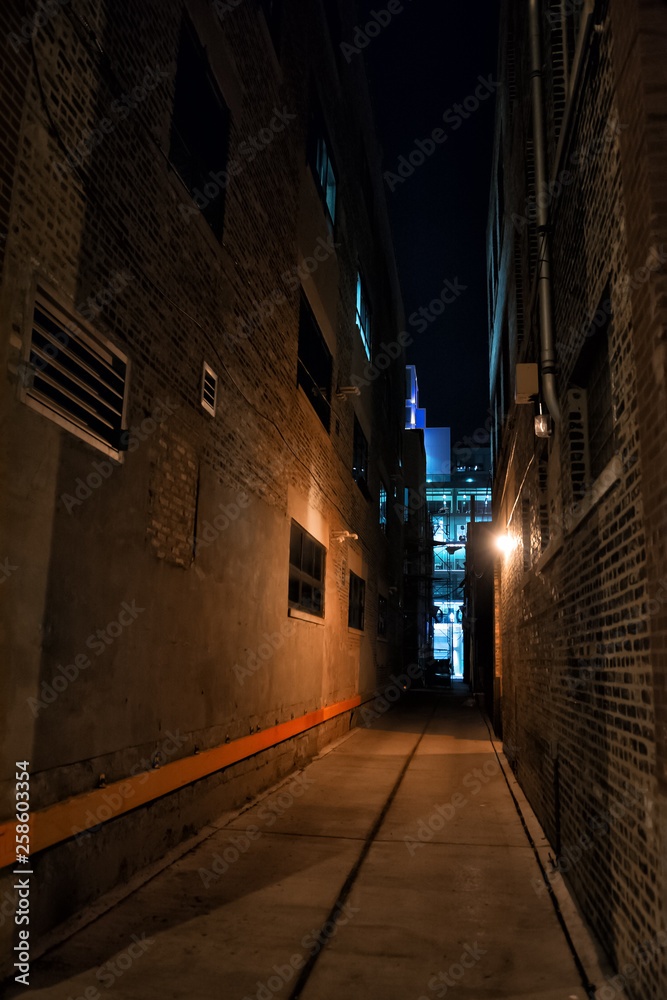 Scary and dark urban city alley at night in Chicago