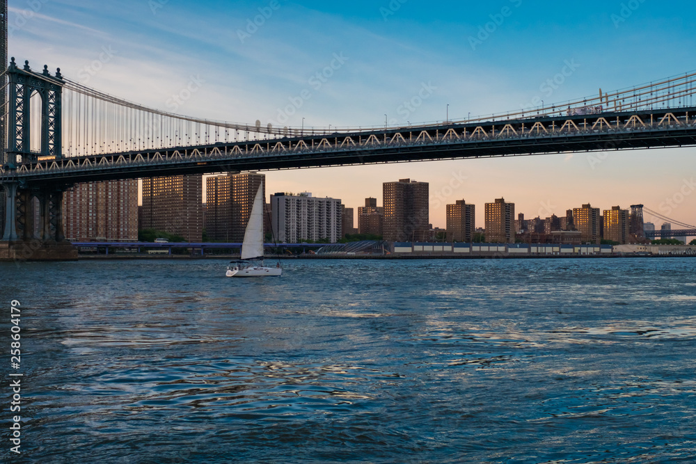 View of the Brooklyn bridge during a dusk from East river. New York City View of the Brooklyn bridge during a dusk from East river. New York City