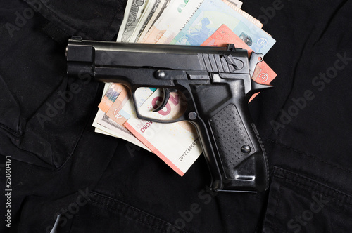 Obraz na plátně Money and weapons. Money and a gun. Buying a weapon.