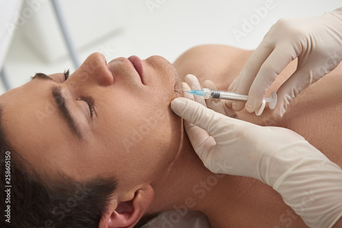 Εκτύπωση καμβά Young man on rejuvenate procedure of chin