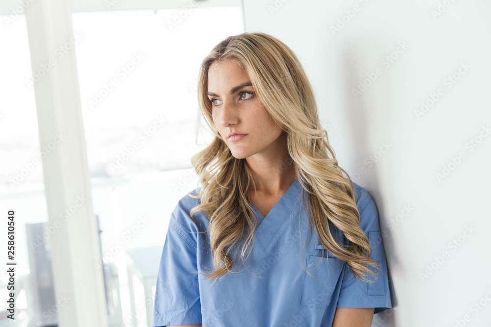 Nurse in Blue Scrubs Looking Grumpy Nurse in Blue Scrubs Looking Grumpy