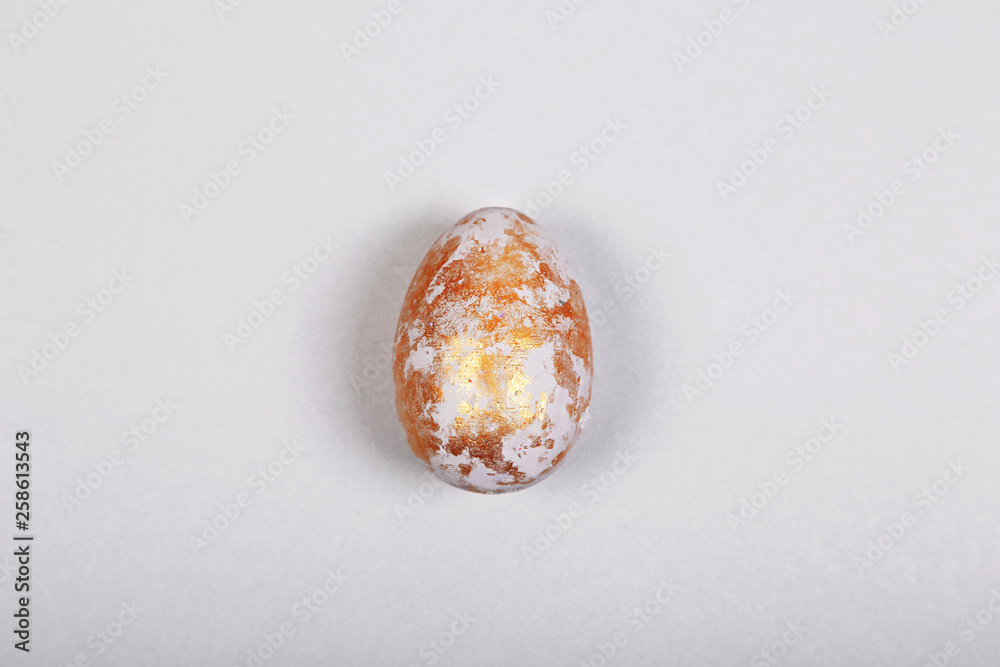 Easter gray golden egg on gray background. Easter concept. Minimalism. Top view, flatlay Easter gray golden egg on gray background. Easter concept. Minimalism. Top view, flatlay