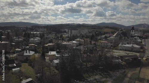 Gorlice, Poland - 3 9 2019: Panorama of the historic center of the European medieval city on the picturesque green hills. Trips to architectural monuments, temples, quarters and sports complex MOSiR photo