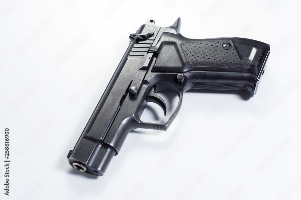 Fire pistol at an angle. Pistol on a gray background.