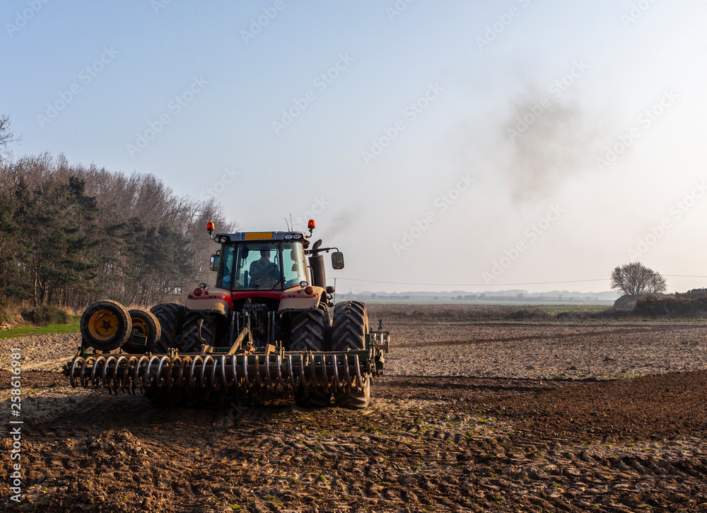 Fototapeta premium tractor plowing the land