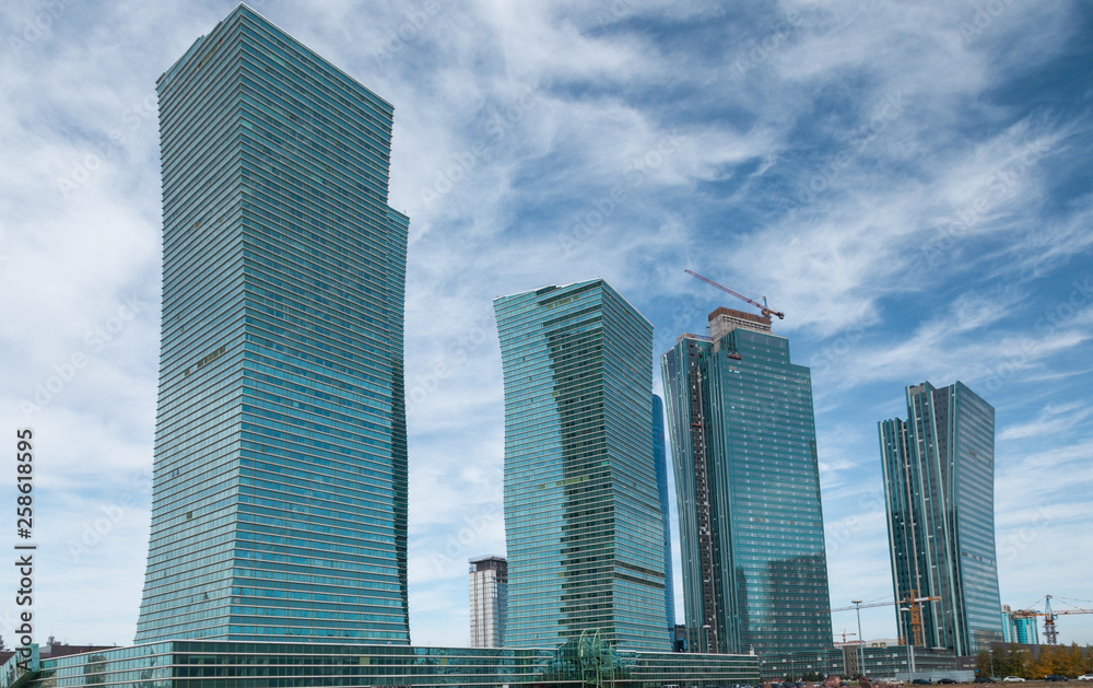 Skyscrapers of Emerald Quarter under construction in the sky, at he NurZhol boulevard, Nur-Sultan  Astana. Nur-Sultan is the capital city of Kazakhstan and the second-largest city in country.