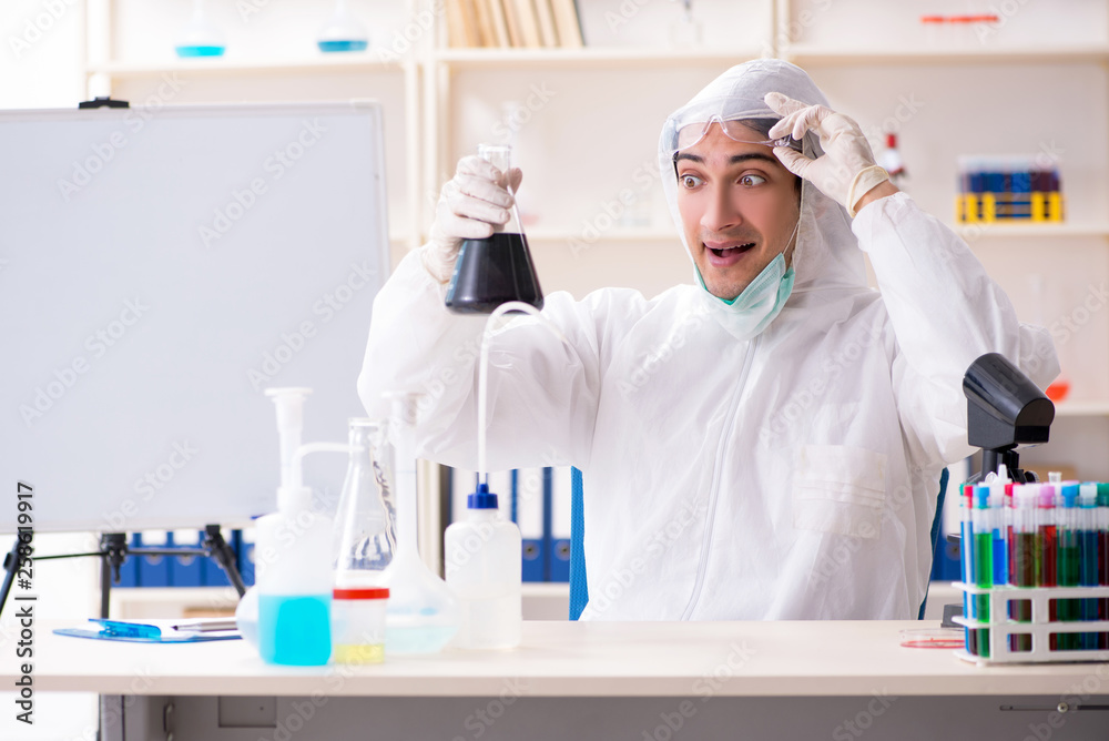 Young handsome chemist working in the lab Young handsome chemist working in the lab
