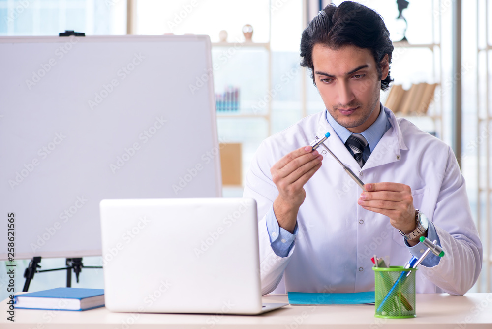 Young handsome doctor in front of whiteboard 