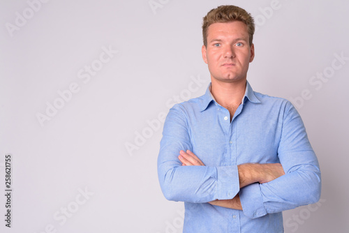 Portrait of young blonde businessman with arms crossed © Ranta Images