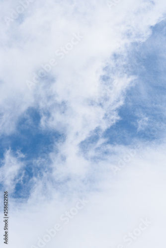 Wispy white clouds against a blue sky as a nature background