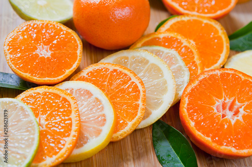 Citrus - satsuma, tangerine, orange Lemon, lime, mandarin and fresh slices. Wooden background, flat lay, top view position.