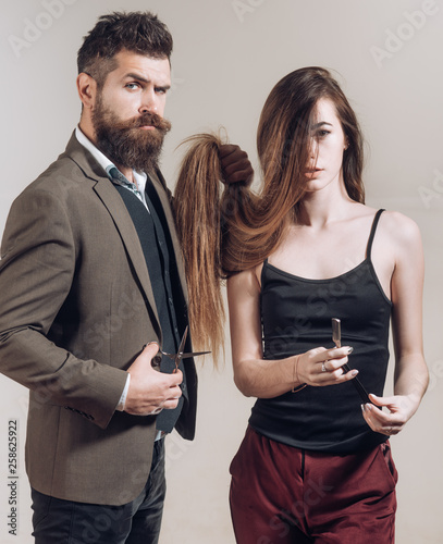 Barber shop tools on gray background. Bearded man anm woman with long hair. Barber shop design. Vintage barber shop. Razor sharp. Barbershop. Barber scissors. photo