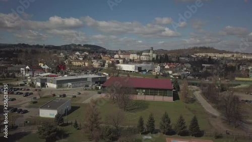 Gorlice, Poland - 3 9 2019: Panorama of the historic center of the European medieval city on the picturesque green hills. Trips to architectural monuments, temples, quarters and sports complex MOSiR photo