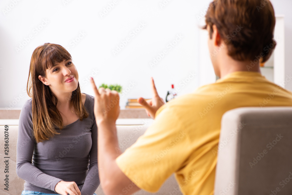 Woman and man learning sign language Woman and man learning sign language