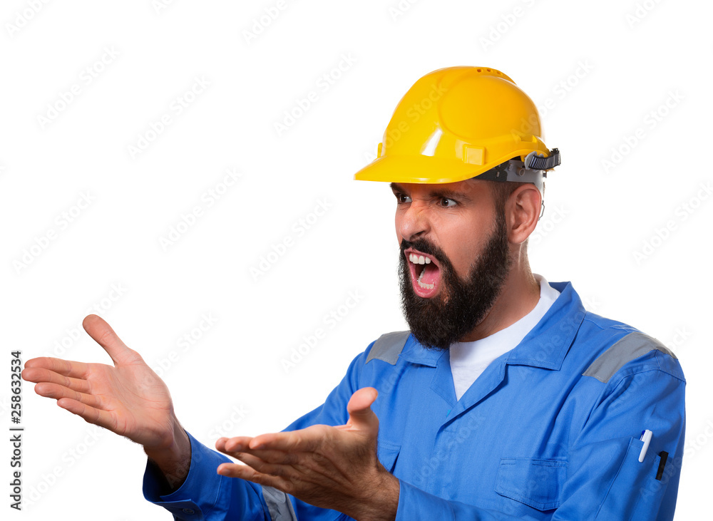 Screamimg bearded builder in hard hat or in helmet. Portrait of unhappy architect builder with open palms, over white background