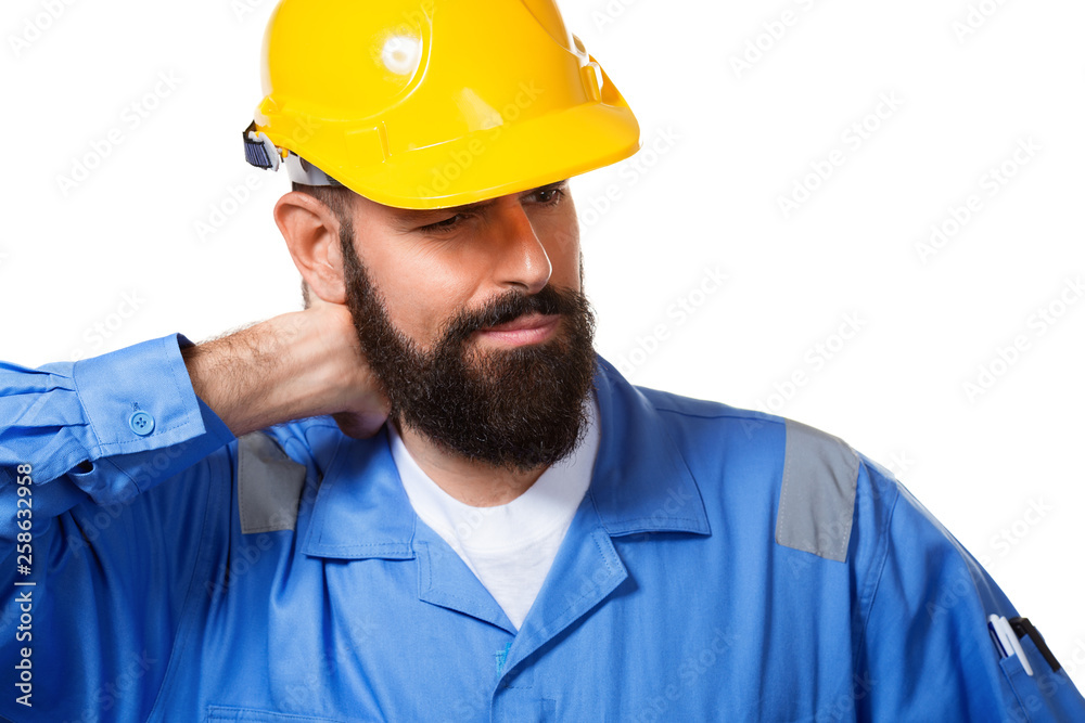 Bearded constructor or builder or foreman in the yellow helmet suffering neck pain. Health insurance concept. Isolated over white background Bearded constructor or builder or foreman in the yellow helmet suffering neck pain. Health insurance concept. Isolated over white background