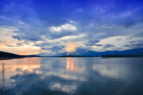 Incredibly beautiful sunset.Sun,sky,lake.Sunset or sunrise landscape, panorama of beautiful nature. Sky with amazing colorful clouds.Water reflections.Magic Artistic Wallpaper.Blue Background.Light.