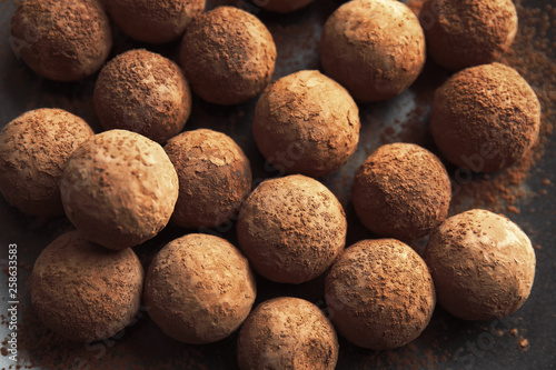 Tasty chocolate truffles on dark background, closeup