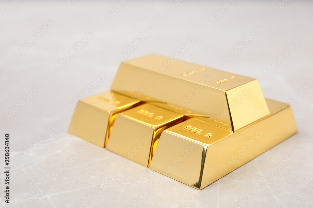 Stack of shiny gold bars on table Stack of shiny gold bars on table