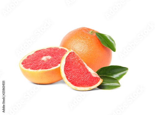 Whole and cut ripe grapefruits isolated on white