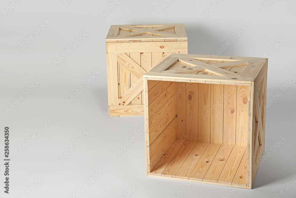 Wooden crates on light background, space for text. Shipping containers Wooden crates on light background, space for text. Shipping containers