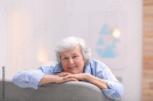 Portrait of beautiful grandmother in living room