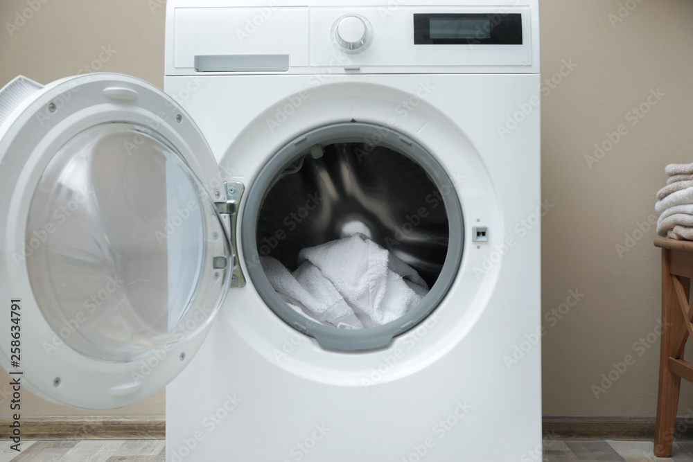 Washing machine with dirty towel in laundry room Washing machine with dirty towel in laundry room