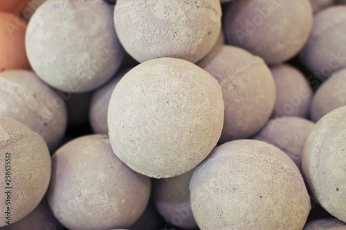 Close up photo of a stack of large, tan bath bombs at a wellness spa