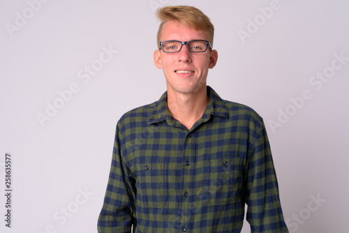 Happy young blonde hipster man with eyeglasses smiling © Ranta Images