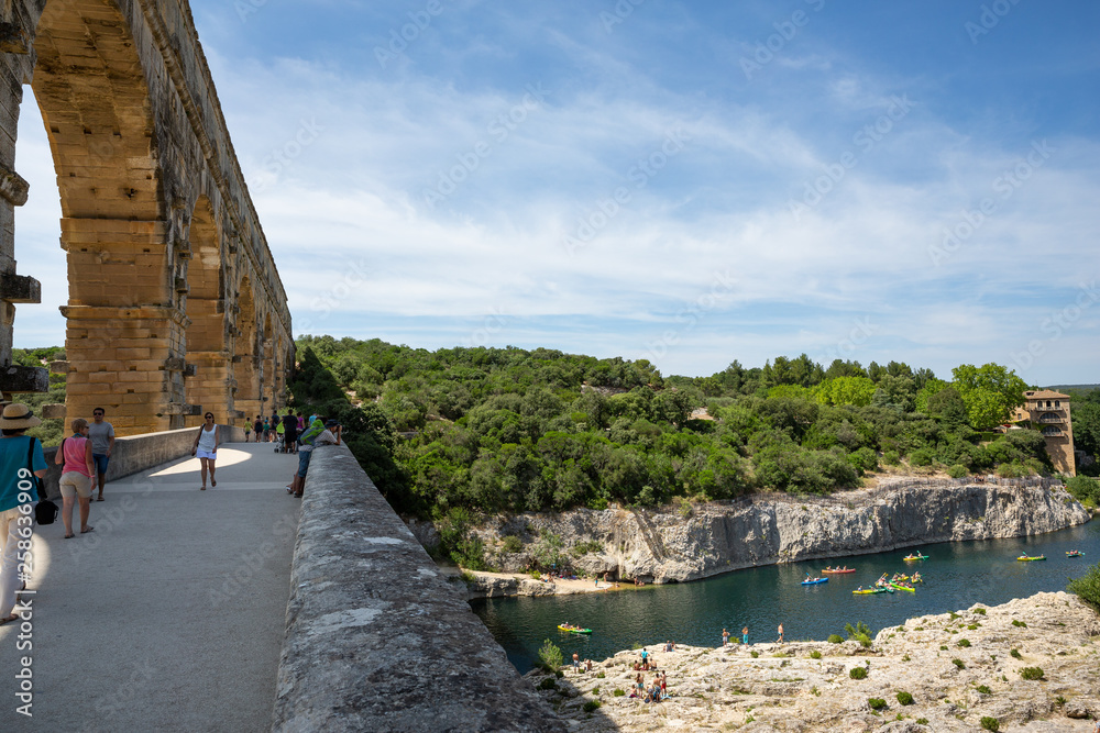 Gard, France July 13th 2015 : The magnificent three tiered Pont Du Gard aqueduct was constructed by Roman engineers in the 1st century AD in the south of France Gard, France July 13th 2015 : The magnificent three tiered Pont Du Gard aqueduct was constructed by Roman engineers in the 1st century AD in the south of France