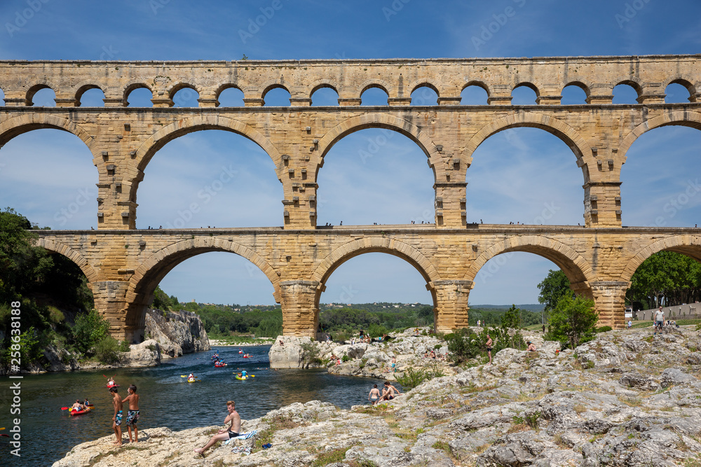 Gard, France July 13th 2015 : The magnificent three tiered Pont Du Gard aqueduct was constructed by Roman engineers in the 1st century AD in the south of France Gard, France July 13th 2015 : The magnificent three tiered Pont Du Gard aqueduct was constructed by Roman engineers in the 1st century AD in the south of France