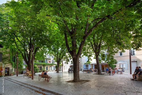 St Remy de Provence France July 13th 2015 : Locals enjoying a drink in a leafy square in St Remy, Provence