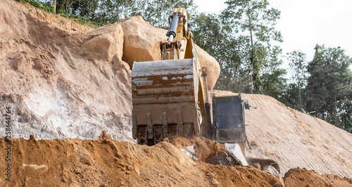 An excavator loader machine during earthmoving works at construction site.