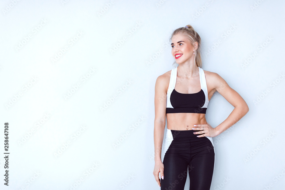 Young blond woman with healthy body posing in studio. Young blond woman with healthy body posing in studio.