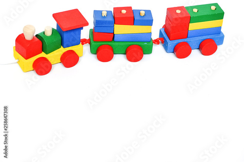 Colorful steam locomotive on a white background Kids toys background. Frame with place for text.Toy. Present. Copy space. Transport.