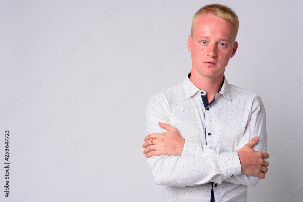 Portrait of young blonde businessman with arms crossed